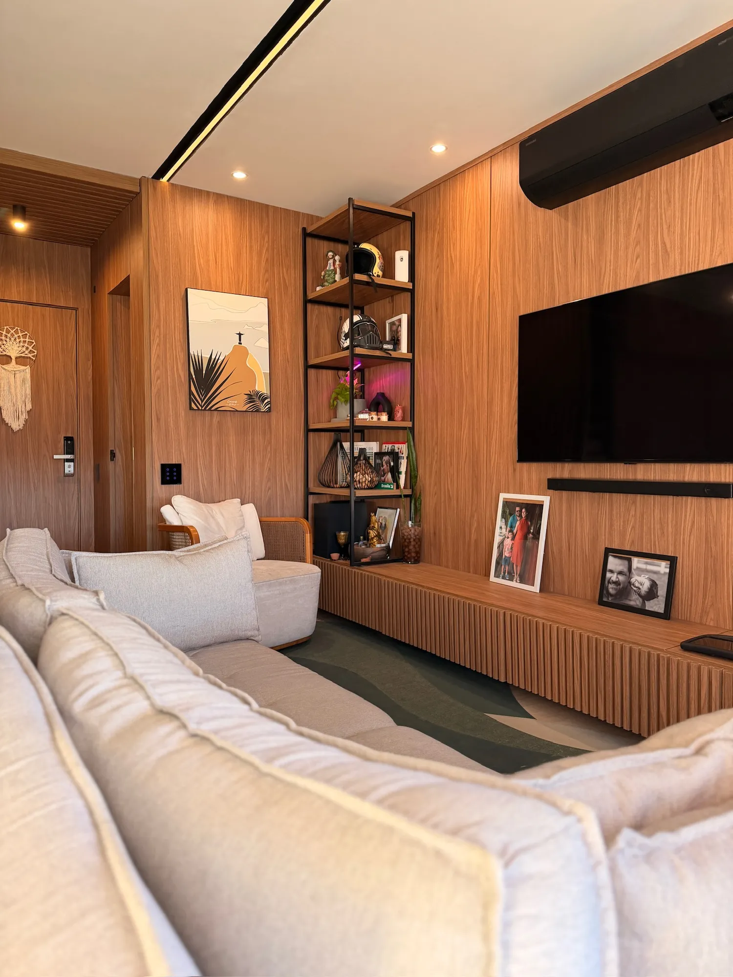 Sala de estar com home, estante e sofá amplo